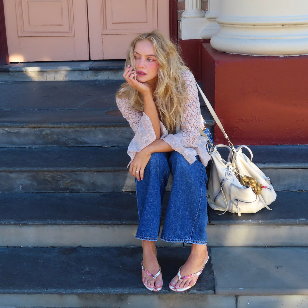 Women getting dressed to go out and wearing Pointed Theory freesia sandal. 