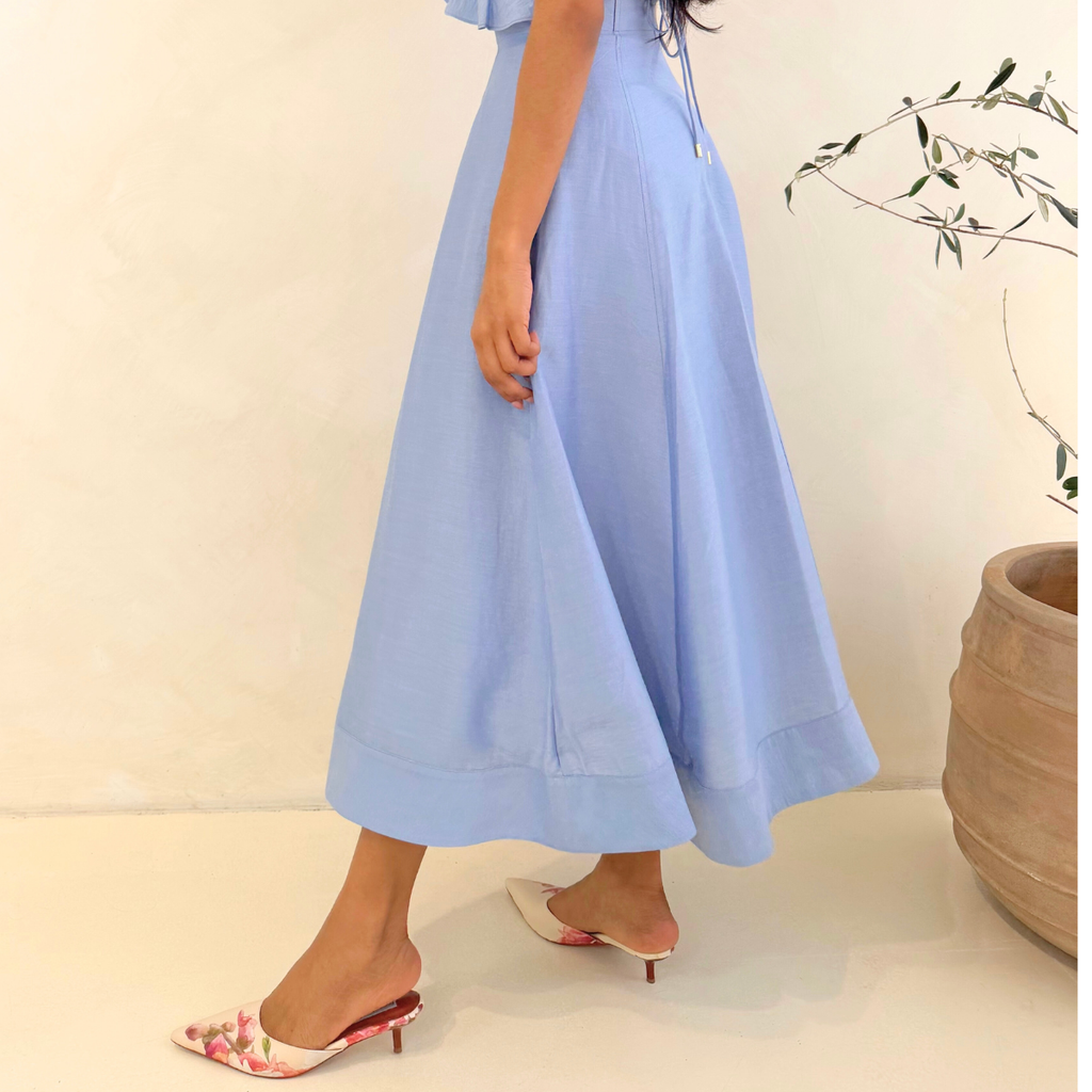Women in white dressing up for outing and wearing Pointed Theory flora mule kitten heels. 